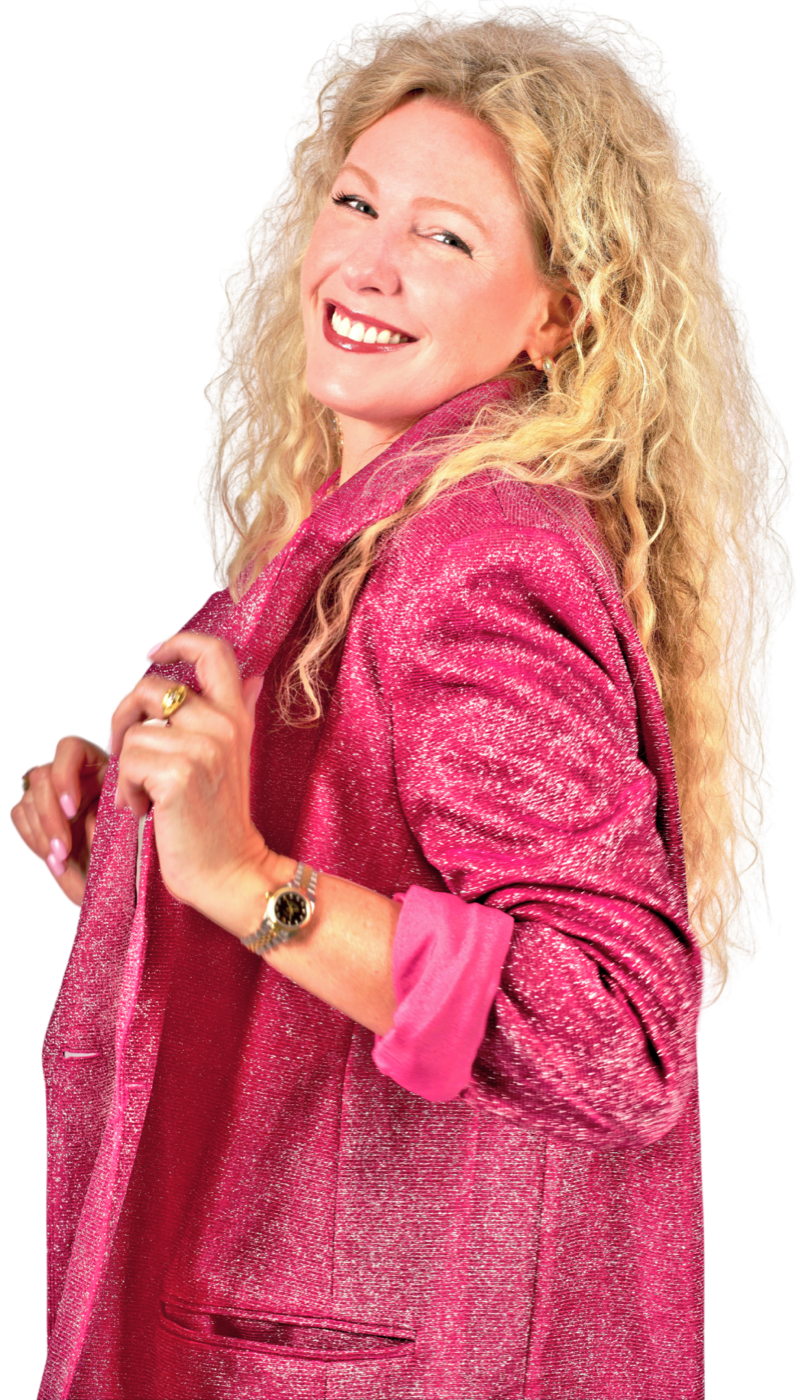 Jess Hughes in a pink glitter blazer, smiling over her shoulder